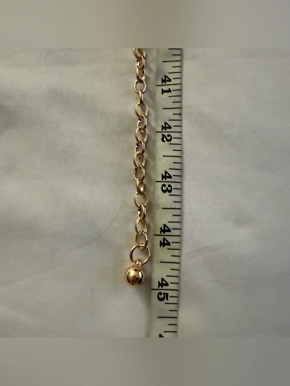 Gold tone oval links metal chain belt with rhinestone details